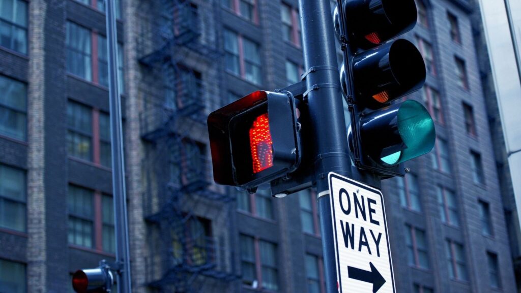 a green arrow showing with a red traffic light means