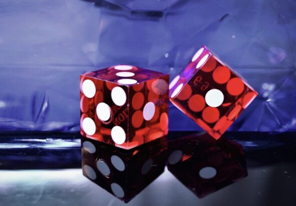 A pair of red dice with white dotsAI-generated content may be incorrect.